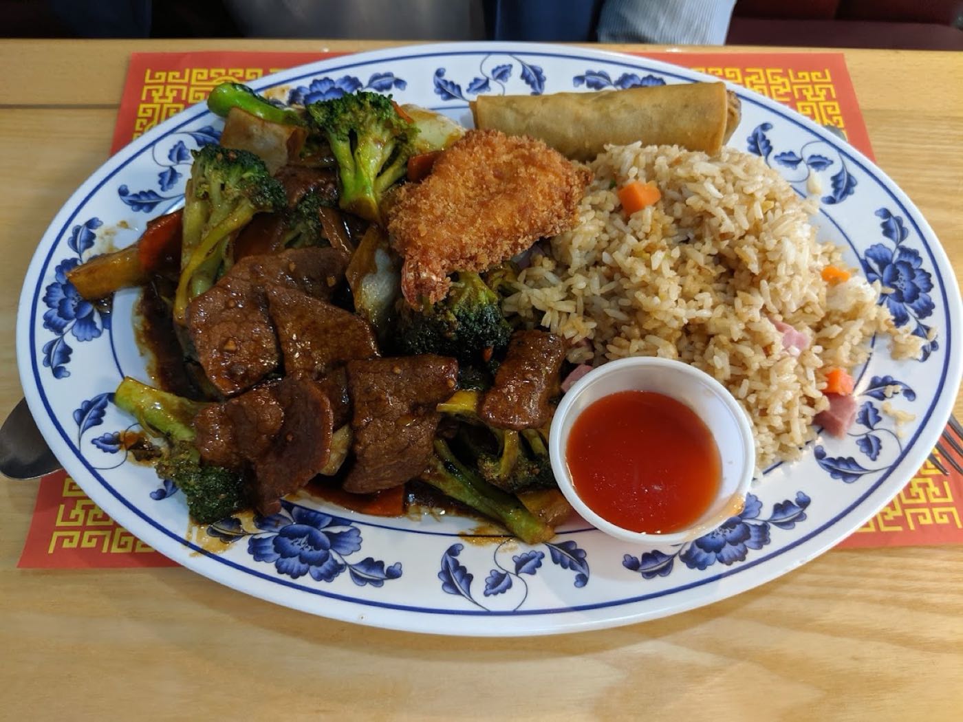 Beef and broccoli served on the house plate at the dining room table