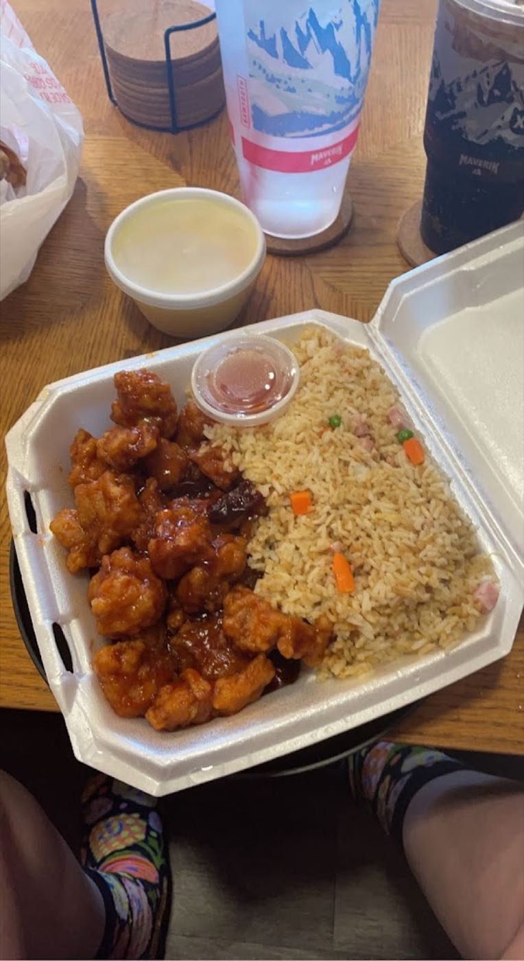 Orange chicken with fried rice in a takeout container