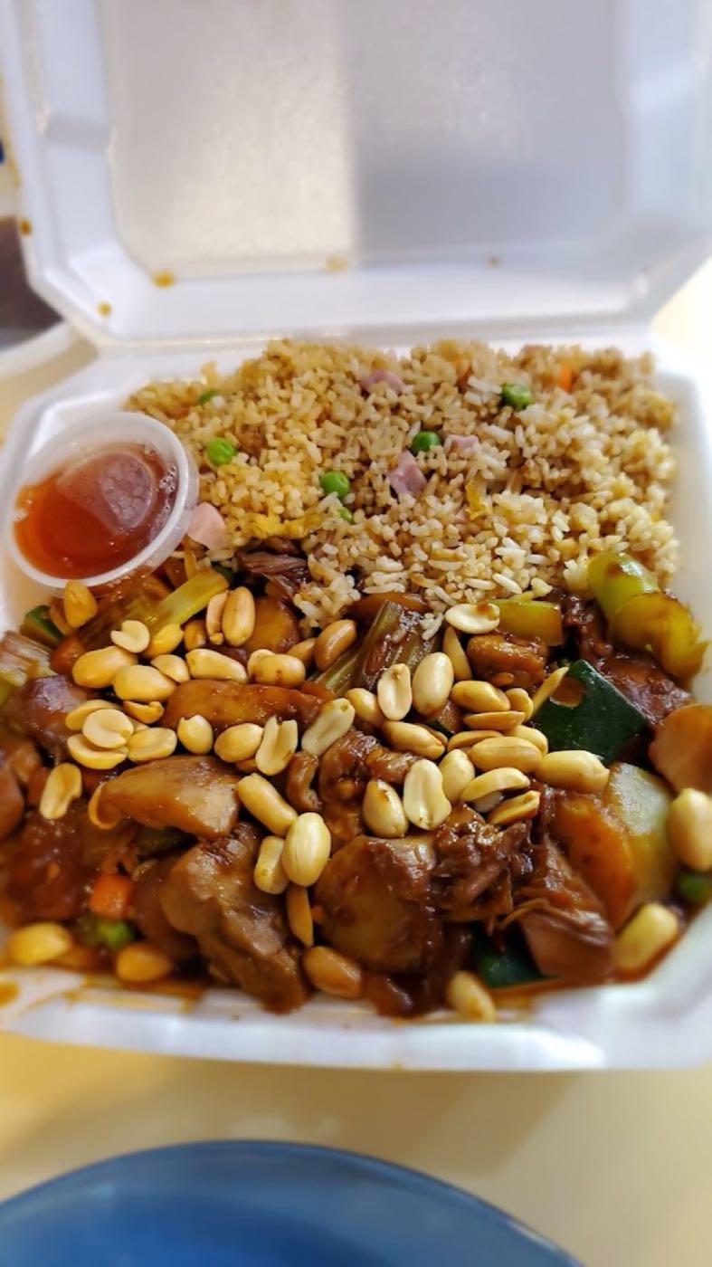 Kung pao chicken with peanuts, zucchini and celery over fried rice