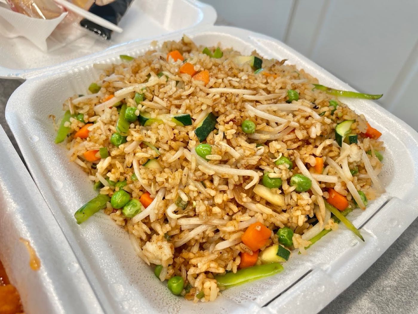 Vegetable fried rice with bean sprouts, zucchini, peas and carrots